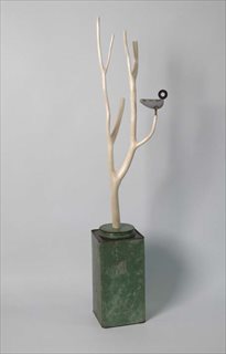 Domestic Bird [2010] poplar, found tin, paper, paint, steel, brass + wax 84x20x14cm