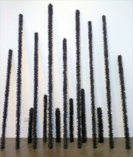 MANDY GUNN <I>Fire Sticks (Burnt Out Series)</i>  [2010-11] shredded inner tubes woven on cotton twine, wood,  aprox. 200 x 250 x 40 cm